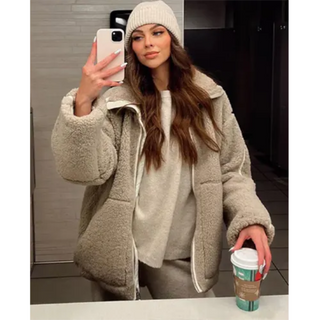 A women's cozy high collar jacket in a relaxed fit, made from soft, warm fabric, ideal for winter wear. The stylish design features a modern silhouette 1